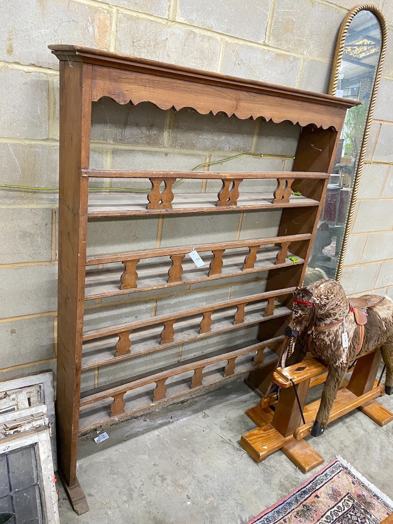 A 19th century Continental fruitwood plate rack, width 130cm height 170cm